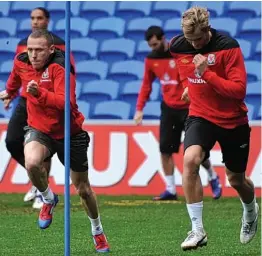  ??  ?? Leading the way: Craig Bellamy (left) races with Jack Collison