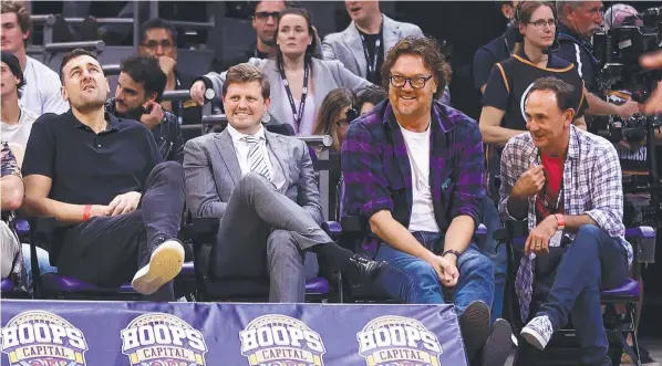  ?? ?? Andrew Bogut (left) and Luc Longley (second from right) watch game one of the NBL Grand Final series. (Photo by Mark Kolbe/Getty Images)