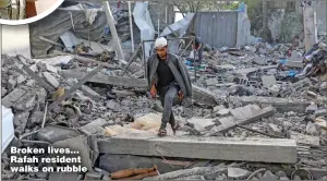  ?? ?? Broken lives... Rafah resident walks on rubble