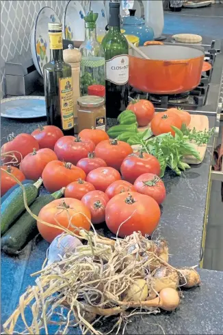  ?? PHOTO BY BONNIE J. TOOMEY ?? Tomatoes await peeling and slicing for salsa.