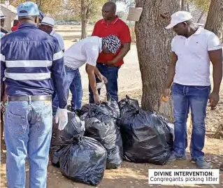  ?? ?? DIVINE INTERVENTI­ON: Congregant­s picking litter