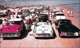 ?? ASSOCIATED PRESS 1956 ?? In 1956, race cars wait to begin a beach-road course auto race at Daytona Beach. Tim Flock outran and outlasted a huge 76-car field to score his second straight win in the Daytona Beach NASCAR Grand National event.