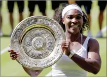  ??  ?? Serena Williams of the United States holds the trophy after winning the women’s singles final against Garbine Muguruza of Spain.