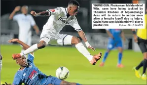  ?? Picture: GALLO IMAGES ?? YOUNG GUN: Phakamani Mahlambi of Wits, seen here being tackled by Thandani Khuboni of Mpumalanga Aces will to return to action soon after a lengthy layoff due to injury. Gavin Hunt says Mahlambi will play a pivotal role