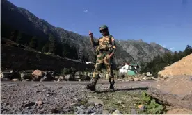  ?? Photograph: Anadolu Agency/Getty Images ?? An Indian border security force soldier walks near a check post along the SrinagarLe­h National highway on Tuesday, following deadly clashes along the disputed border with China.