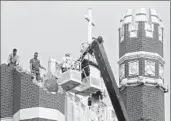  ?? Sue Ogrocki Associated Press ?? DAMAGE at St. Gregory’s University in Shawnee, Okla., is inspected after a magnitude 5 earthquake.