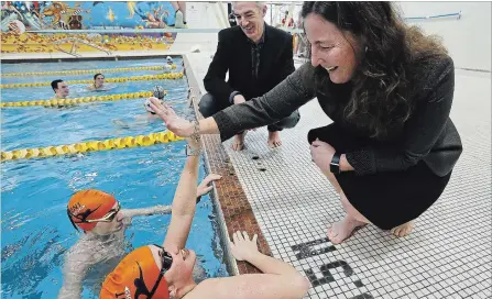  ?? CLIFFORD SKARSTEDT/EXAMINER ?? Dad Jamie Tompkins and mom Stephanie cheer on son Patrick, 14, and daughter Taylor, 12, at the Trent Athletics Centre pool in Peterborou­gh.