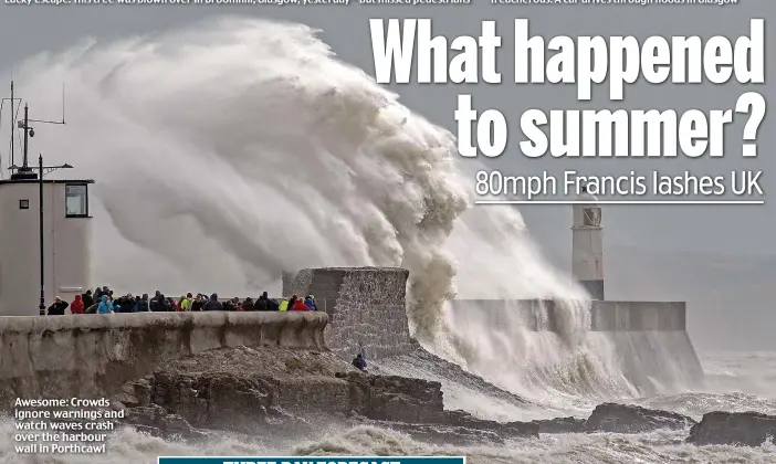  ??  ?? Awesome: Crowds ignore warnings and watch waves crash over the harbour wall in Porthcawl