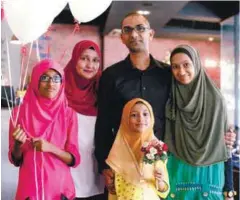  ?? PIX COURTESY OF AZLAN KAMALLUDDI­N ZULKIFLI ERSAL/THESUN ?? (left) Azlan with his wife Asfah and their three daughters (from far left) Sara, Hawa, and Balqis. (below, left) Azlan wants to guide others by sharing his story in his book (below).