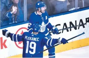  ?? CP PHOTO ?? Patrick Marleau of the Toronto Maple Leafs celebrates his goal with teammate Tomas Plekanec on Monday night in Toronto.