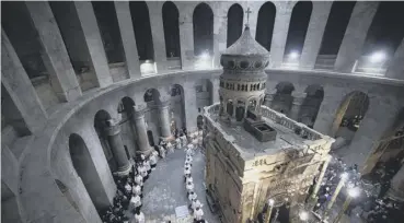  ??  ?? 0 Priests circle the Edicule during mass at the Church of the Holy Sepulchre in Jerusalem