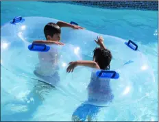  ?? PHOTO MICHAEL MARESH ?? Children float down the lazy river pool at the el Centro Aquatic Center grand opening.