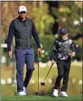 ?? Mike Ehrmann / Getty Images ?? Tiger Woods and son Charlie look on on the 18th hole during the Pro-Am for the PNC Championsh­ip at the Ritz Carlton Golf Club in Orlando, Fla., on Friday.