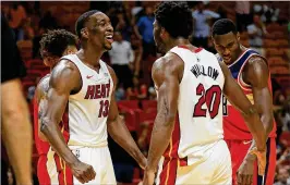  ?? MIKE EHRMANN / GETTY IMAGES ?? First-round draft pick Bam Adebayo (left) celebrates with Justise Winslow after dunking. Adebayo had his best preseason game with 15 points.