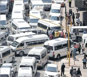  ??  ?? Taxi strike members blockade a street in Johannesbu­rg. A planned protest tomorrow has been called off after an agreement being reached between the involved parties.