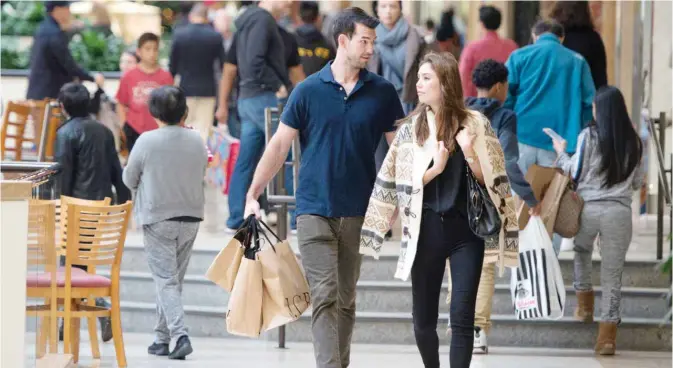  ??  ?? COSTA MESA: Eric Denker and his wife Jalen Denker of Irvine take advantage of sales to buy suits for business school interviews at South Coast Plaza in Costa Mesa, California. The US government issued the November jobs report on Friday.—AP