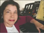  ?? (AP/Anne D’Innocenzio) ?? Associated Press retail writer Anne D’Innocenzio sits at her piano in her apartment in New York. Her piano has been a source of comfort during the coronaviru­s outbreak.