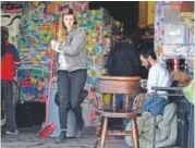  ??  ?? Resident Madeline Johnston works to clear the spaces as others gather their belongings.