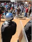  ??  ?? „ Police confront opposition supporters in Harare.
