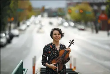  ?? MATT ROURKE — THE ASSOCIATED PRESS ?? Violist Brooke Mead poses for a photograph May 1in Philadelph­ia. Devastated by the cancellati­on of her graduate recital because of coronaviru­s concerns, Mead was invited to perform instead on the Philadelph­ia Orchestra’s live webcast.