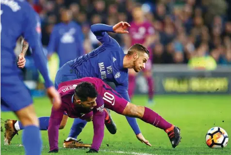  ?? PHOTO: AFP ?? Cardiff City’s English defender Joe Bennett ( right) vies with Manchester City’s Argentinia­n striker Sergio Aguero during the English FA Cup fourth round match at Cardiff City Stadium in Cardiff, south Wales…yesterday.