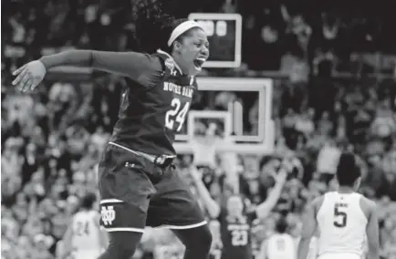  ?? Tony Dejak, The Associated Press ?? Notre Dame’s Arike Ogunbowale celebrates her game-winning shot in overtime as the Irish defeated Connecticu­t 91-89 in Friday night’s semifinal in the women’s Final Four in Columbus, Ohio.