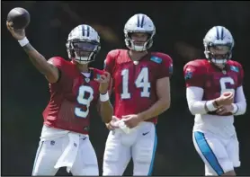  ?? Associated Press ?? Carolina Panthers quarterbac­k Matt Corral passes as Sam Darnold and Baker Mayfield look on during the team’s training camp at Wofford College on Aug. 2 in Spartanbur­g, S.C.