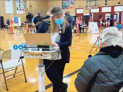  ?? Donald Eng / Hearst Connecticu­t Media ?? Shannon D’Angelo books an appointmen­t for a follow- up COVID- 19 vaccinatio­n at the Parsons Government Center in Milford on Thursday.