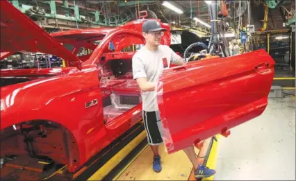  ?? REBECCA COOK / REUTERS ?? A Ford Motor worker assembles a Mustang at the company’s plant in Flat Rock, Michigan, on Aug 20, 2015.