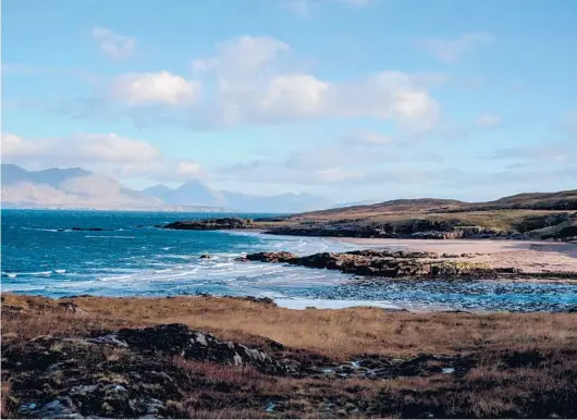  ?? ANDREW TESTA/THE NEW YORK TIMES PHOTOS ?? The beach at Kilmory on Dec. 1 on Scotland’s Isle of Rum. In the background is the Isle of Skye, which has the closest pub.