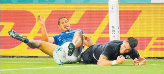  ?? Photo / Photosport ?? Kilted Kiwi Sean Maitland loses the ball in a dangerous tackle and Scotland were subsequent­ly awarded a penalty try.