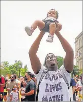  ?? AFP/REUTERS ?? (Left) Demonstrat­ors gather at the Lincoln Memorial during a protest against racism, and (right) a man holds up a child during the protest, in Washington, DC