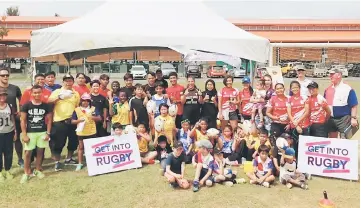  ??  ?? Participan­ts posing for the ‘Get Into Rugby’ session at the Miri Municipal Council field in October last year.