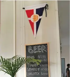  ??  ?? The Royal Suva Yacht Club pennant points to beer prices.