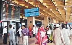  ?? AFP ?? Passengers arrive at Jinnah Internatio­nal Airport, in Karachi. Picture for illustrati­ve purposes only.