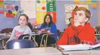  ?? SUE OGROCKI/THE ASSOCIATED PRESS ?? Students listen during a seventh-grade English class at Newcastle Middle School in Newcastle, Okla. Newcastle Public Schools has moved to a four-day school week in response to Oklahoma’s budget woes.