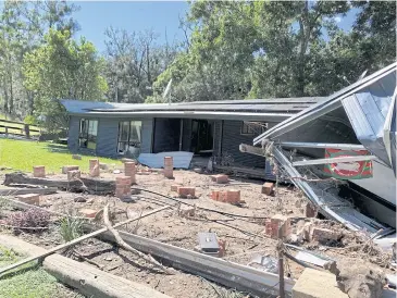  ??  ?? ABOVE
The home of Australian cattle farmer Robert Costigan was swept off its foundation­s by floodwater in Hollisdale.