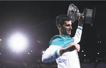  ?? Matt King / Getty Images ?? Novak Djokovic of Serbia holds the Norman Brookes Challenge Cup as he celebrates his victory in the Australian Open men’s singles final against Russia’s Daniil Medvedev in Melbourne.