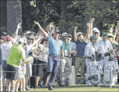  ?? MATT SLOCUM / ASSOCIATED PRESS ?? Matt Kuchar exults from the tee box on the 16th hole as his tee shot winds up in the hole, registerin­g a rare hole-in-one in Sunday’s final round of the Masters, where he finished tied for fourth place.