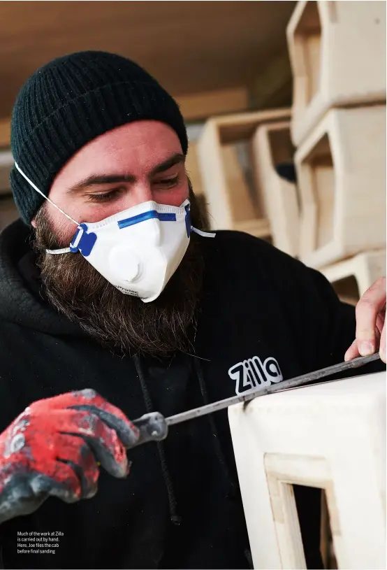  ??  ?? Much of the work at Zilla is carried out by hand. Here, Joe files the cab before final sanding