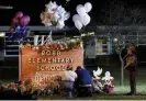  ?? Photograph: Nuri Vallbona/Reuters ?? Stephanie and Michael Chavez of San Antonio pay their respects at a makeshift memorial outside Robb elementary School.