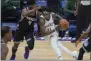  ?? RANDALL BENTON - THE ASSOCIATED PRESS ?? Sacramento Kings guard Terrence Davis (9) defends against Milwaukee Bucks guard Jrue Holiday (21) during the second half of an NBA basketball game in Sacramento, Calif., Saturday, April 3, 2021.