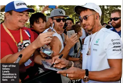  ?? EPA ?? Sign of the times: Lewis Hamilton is mobbed by fans