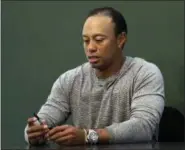  ?? SETH WENIG — THE ASSOCIATED PRESS FILE ?? In this March 20 photo, golfer Tiger Woods prepares to sign copies of his new book at a book signing in New York. Woods is receiving help to manage his medication­s.