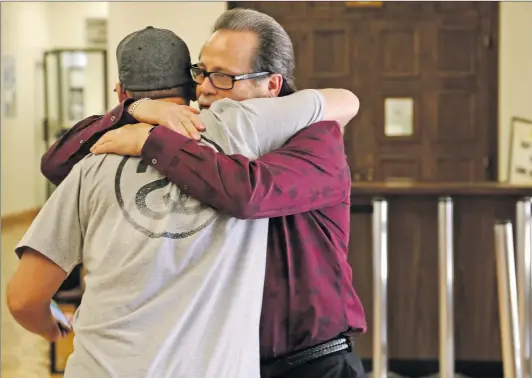  ?? Katharine Lotze/The Signal ?? Cary Quashen, right, hugs Kenneth Fusca, James’ father, after a court hearing where James chose not to appear before the judge, opting for his public defender to appear for him.