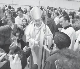  ?? Anne Cusack Los Angeles Times ?? ARCHBISHOP JOSE GOMEZ greets the congregati­on after his first Mass at the Cathedral of Our Lady of the Angels since taking over from Mahony.