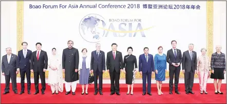  ?? (AP) ?? In this photo released by Xinhua News Agency, Chinese President Xi Jinping (center), and his wife Peng Liyuan (center right), pose for a group photo with foreign leaders attending the Boao Forum for Asia Annual Conference in Boao in south China’s...