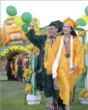  ?? PHOTO ?? Holtville High School’s Class of 2017 Valedictor­ian Cleo Miki and Salutatori­an Jorge Mendoza lead their class into Holtville High’s graduation ceremony on Friday night in Holtville. VINCENT OSUNA