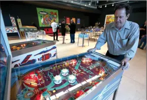  ?? BAY AREA NEWS GROUP PHOTOGRAPH­S BY ANDA CHU ?? Pacific Pinball Museum Executive Director Michael Schiess demonstrat­es one of the museum’s pinball machines that is part of “The Art and Science of Pinball” exhibit at the Chabot Space & Science Center on June 28.