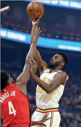  ?? DOUG DURAN — STAFF PHOTOGRAPH­ER ?? Warriors forward Andrew Wiggins — a former No. 1overall draft pick — makes a basket as Houston’s Danuel House Jr. tries to block the shot Thursday night at Chase Center.